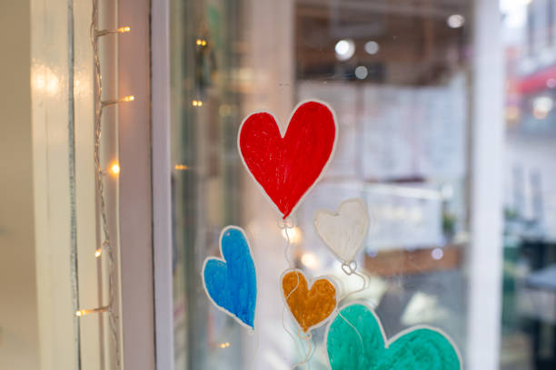 istock A window with a heart painted on it and a bunch of other hearts 2199847904