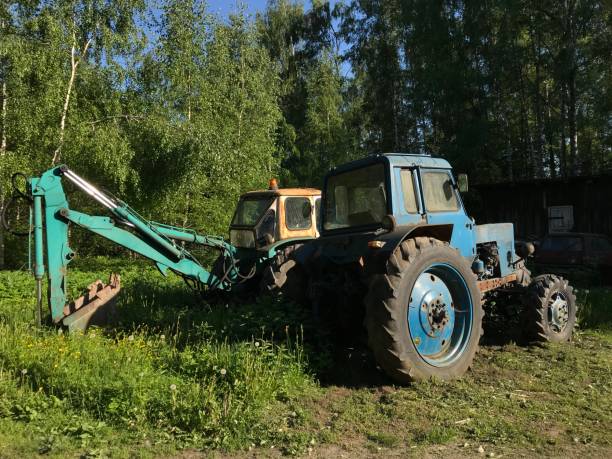 istock Two old excavators in a field awaiting decommissioning 2199850534