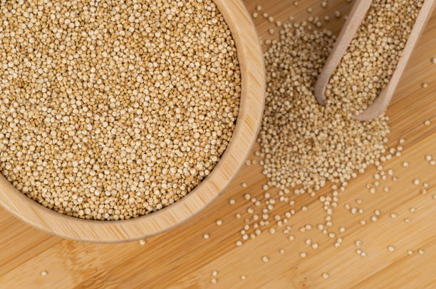 istock Quinoa seeds in a wooden bowl with a scoop on a bamboo surface 2199851115