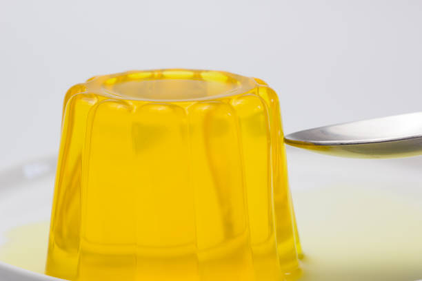 istock Spoon and pineapple-flavored gelatin with white background 2199858993