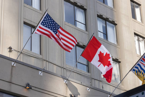 istock United States and Canada Flags Displayed Together on Modern Building 2199860896