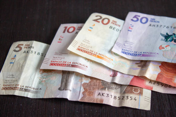 Colombian money on black surface