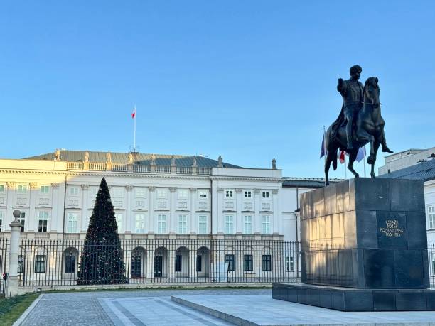 Warsaw, Poland - May 8, 2013: Sculpture of a lion and guards in front of the Polish Presidential Palace by sunny day. Palace is the seat of the Polish president.