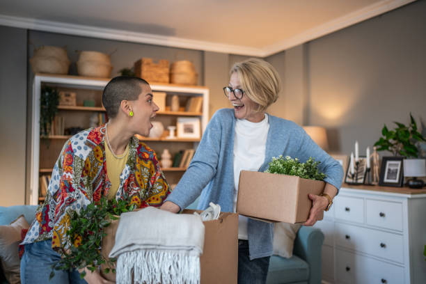 istock Two women unpacking and organizing while moving into a new home 2199875432