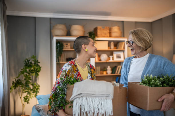 istock Two women unpacking and organizing while moving into a new home 2199875433