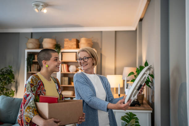 Women unpacking and decorating new home together after moving in