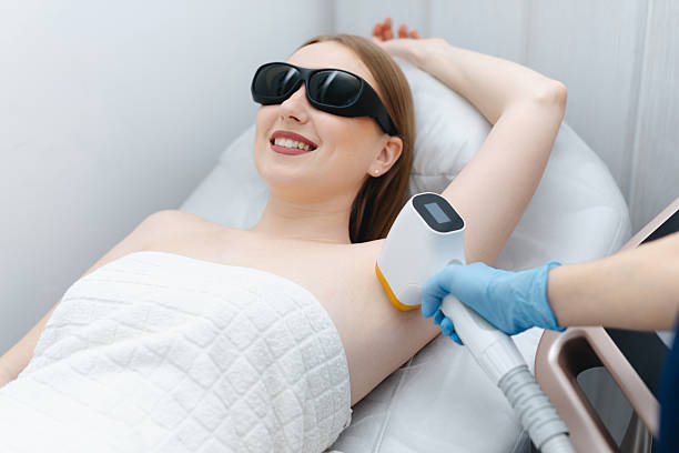 istock young woman on laser epilation procedure 2199877019