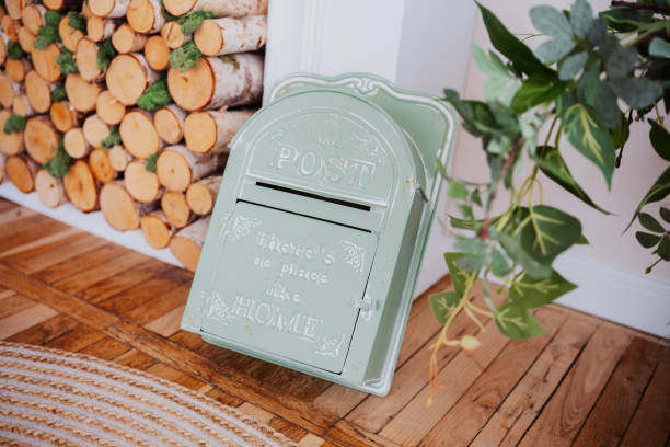 istock Vintage mail box positioned next to wooden logs in a cozy home setting 2199877492