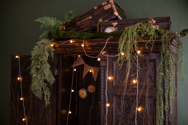 istock Decorative vintage wardrobe adorned with plants and warm lights 2199877512