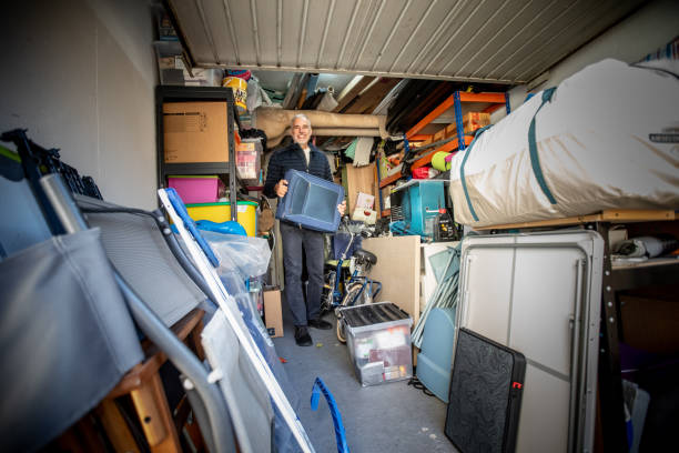 istock Mature man in a Packed Garage holding a suitcase 2199878271