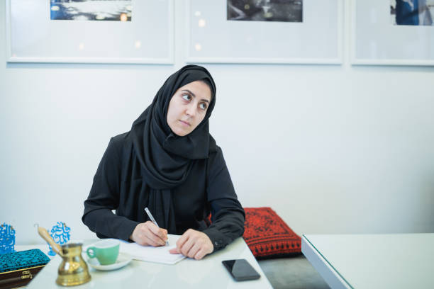 istock Thoughtful Woman Writing in Cafe Morning 2199878346