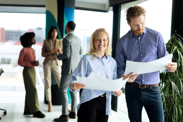 istock Young business team working together and looking at paperwork 2199879201