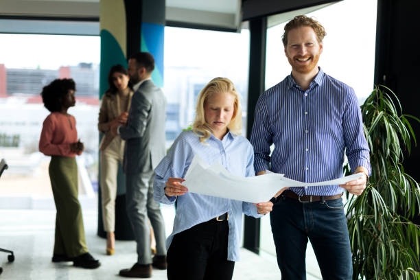 istock Young business team working together and looking at paperwork 2199879203