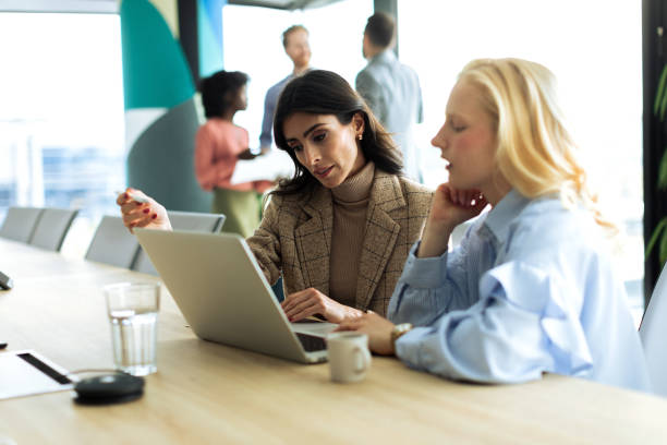 istock Two Successful businesswomen using laptop inside modern office 2199879506