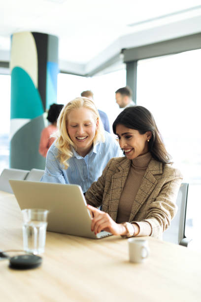 istock Two Successful businesswomen using laptop inside modern office 2199879535