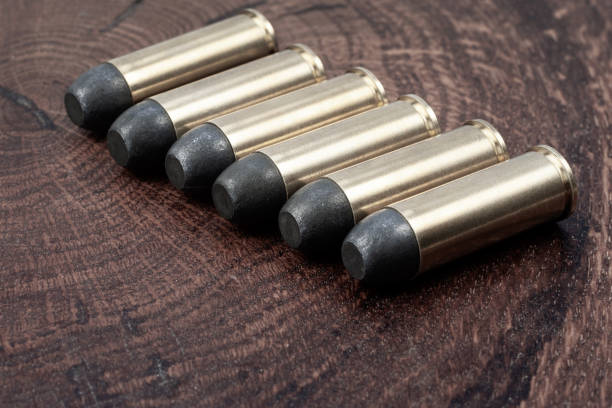 .45 caliber revolver cartridges .45 caliber revolver cartridges on a wooden table forty five caliber handgun stock pictures, royalty-free photos & images