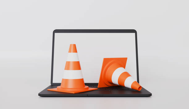 istock Traffic cones with attention on a laptop, Accident prevention concept 2199884145
