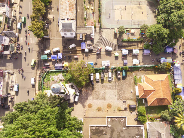 Overhead Drone Shot of the Cicalengka Town square. Panoramic cityscape landscape from a high angle view of mosque with tower and sports court on Town square. Negative Space
