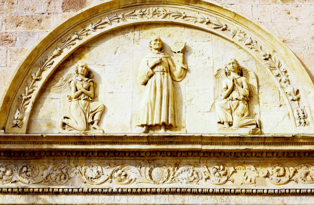 A statue of Saint Anthony stands tall in the church Sainte-Marie-Madeleine, located in Mont de Marsan. The figure holds a child close, symbolizing compassion and care.