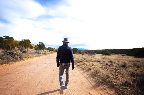 istock Santa Fe, NM: Senior Man Walking on Rural Dirt Road 2199899290