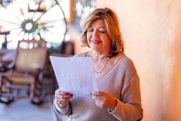 istock Retired woman viewing a documents in her home 2199902281
