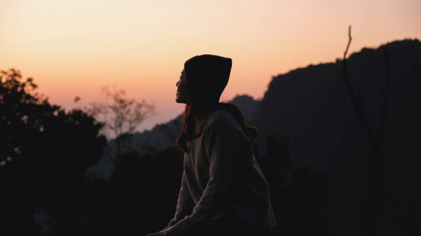 istock A woman looking at mountain views at dawn 2199903054