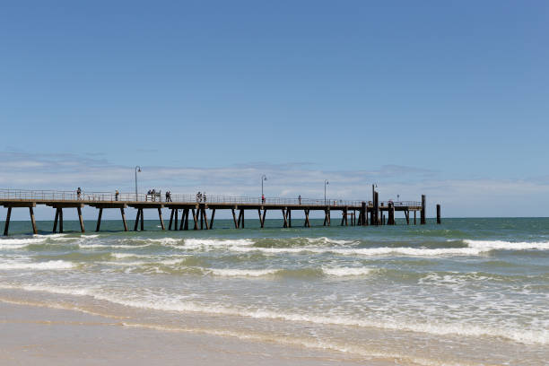 istock Looking across breaking waves toward the Glenelg Jetty 2199909582