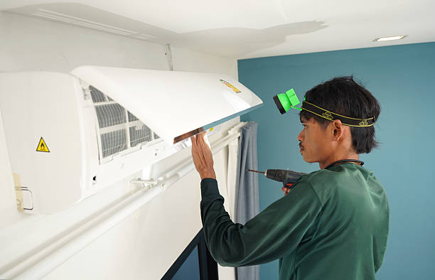 istock The worker cleans and repairs the air conditioner to ensure it operates properly 2199909838