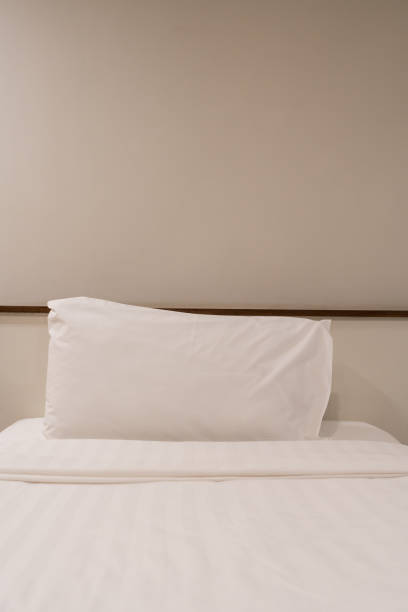 istock White pillows and a white bed linen at hotel bed. 2199912237