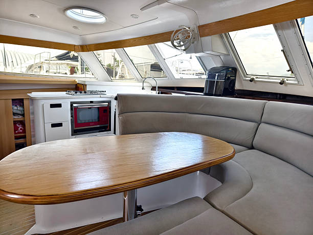 istock A cozy living room and kitchen featuring a stylish curved couch and a table located on sailing boat 2199912442