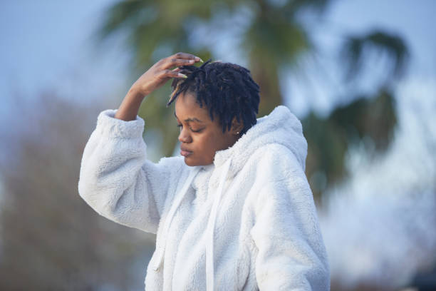 Fashionable white clothing on a black girl at nature parkl background
