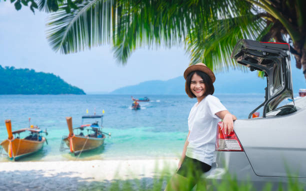 istock Smiling woman on tropical beach road trip 2199914946