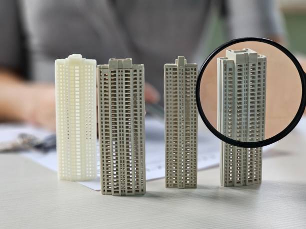 Detailed miniature building models showcased on a workspace during a design presentation concept