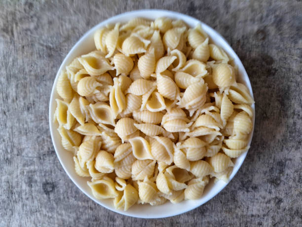 istock Shell Conchiglie Macaroni Pasta On A Plate. Food Menu. Top View. 2199915504