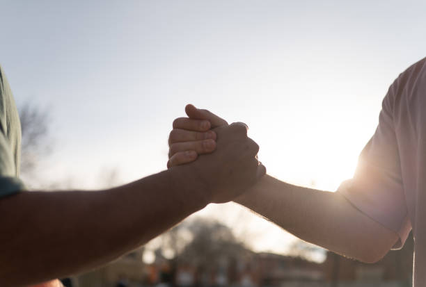Two basketball players shaking hands after the match