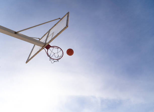 istock Basketball ball entering hoop on a sunny day 2199916082