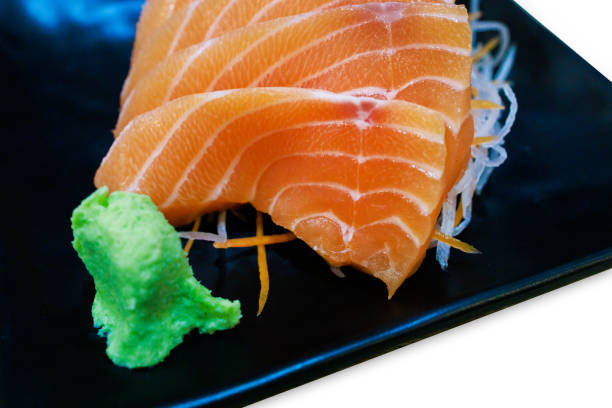 istock Top view of Fresh slice Salmon on the black plate, focus selective 2199919181