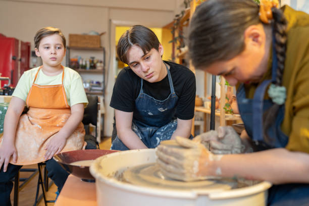 istock Adult student using pottery wheel in art class 2199922755