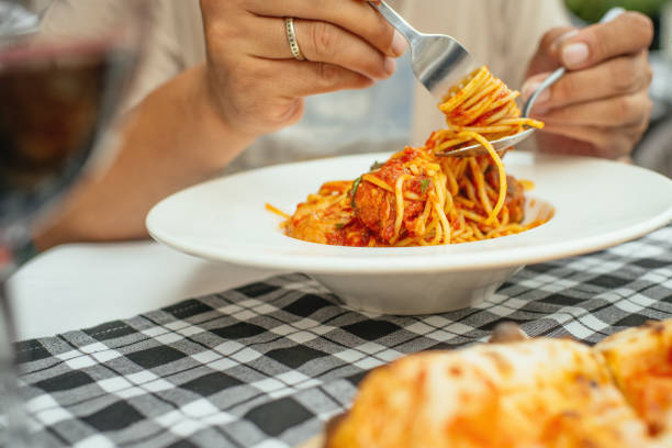 istock Man eating spaghetti pasta with meatballs 2199925578