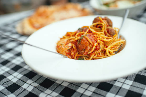 Spaghetti pasta with meatballs on a table in a cafe or restaurant