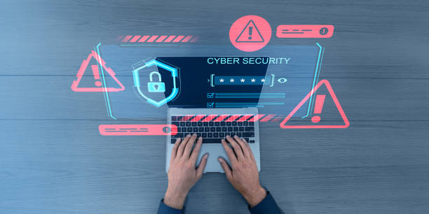 istock Hands typing on laptop with cybersecurity symbols overlay. 2199926388