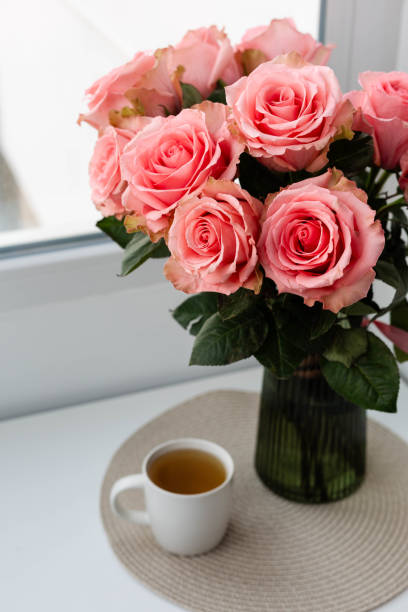 istock Cup of tee and bouquet of roses 2199926552
