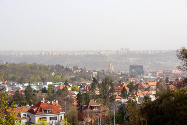 istock .cityscape with many houses and trees under a clear sky. 2199927071
