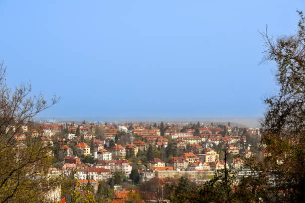 istock .cityscape with many houses and trees under a clear sky. 2199927074