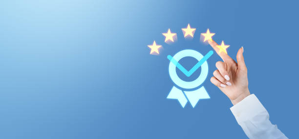 istock Customer hand giving five-star rating with certification icon on blue background. 2199927128