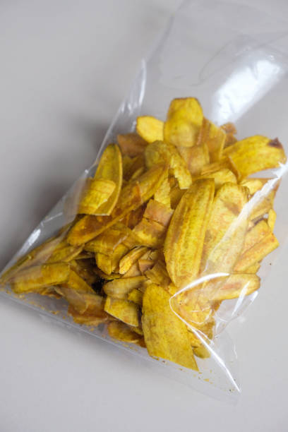 istock Close-up of banana chips in plastic packaging. 2199928508