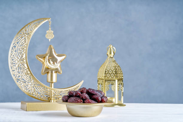istock Traditional lantern lamp with crescent moon with dates fruit.  Ramadan Kareem , Eid Mubarak greeting image 2199931703