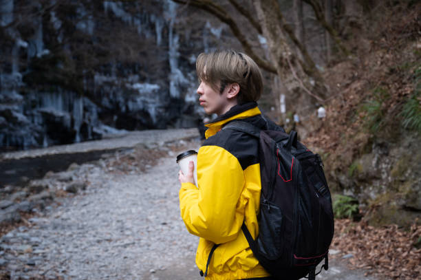 istock A Japanese man/young man enjoying winter sightseeing while holding a coffee cup in his hand 2199932553