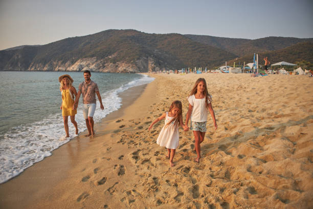 istock A family walks hand in hand down a tropical paradise beach during sunset 2199934211