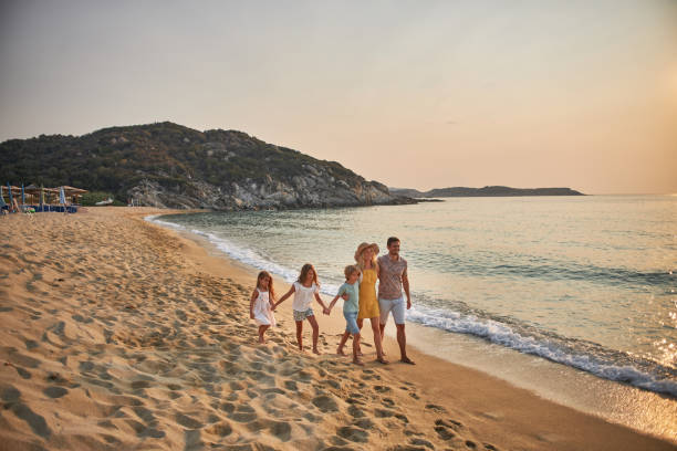 istock A family walks hand in hand down a tropical paradise beach during sunset 2199934988